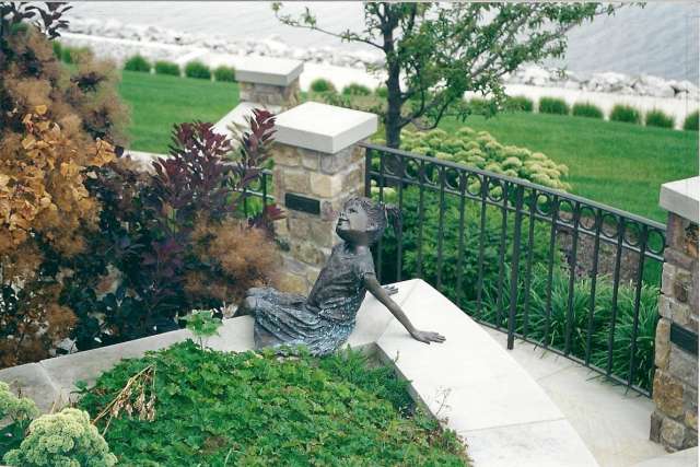 Cleveland area residence features landscaped garden and sculpture overlooking Lake Erie shoreline.